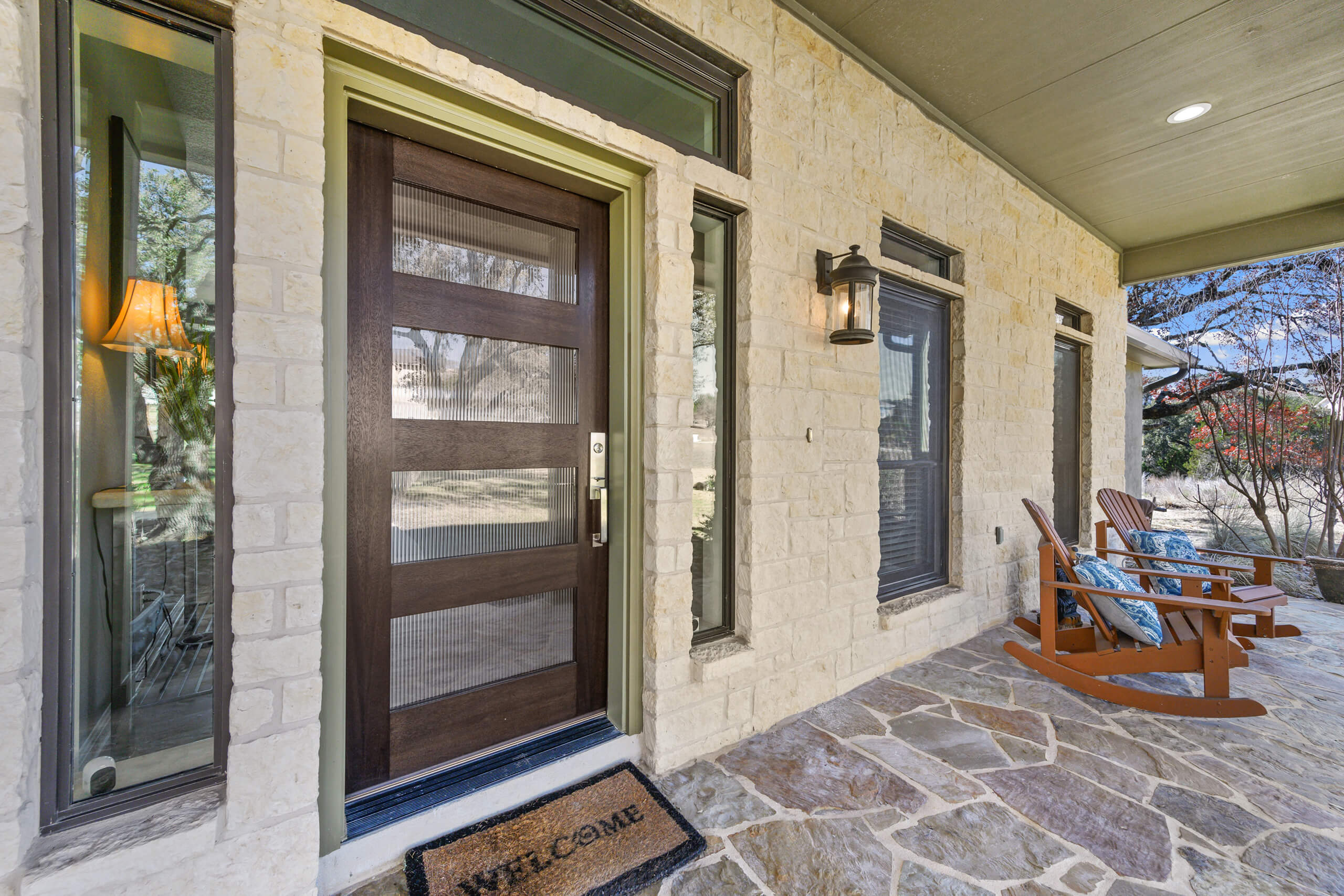 A stylish front door with modern sidelights creates a warm, welcoming entryway that enhances curb appeal and buyer interest.