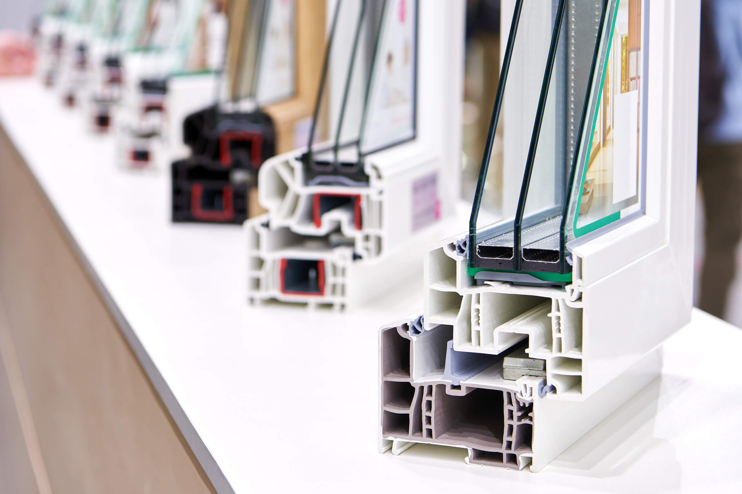 Display of triple-pane window cross-sections showing frame and glass construction.